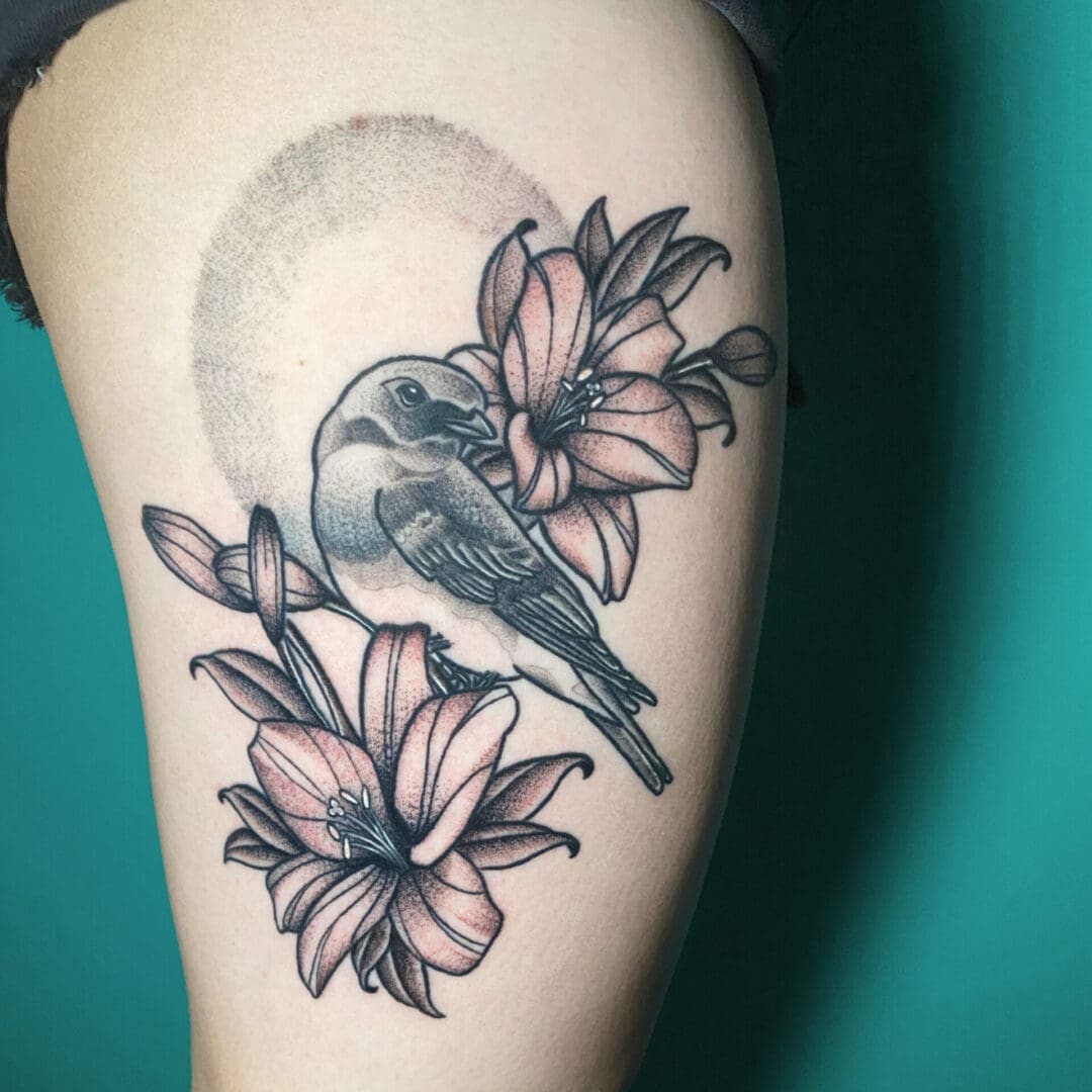 A Beautiful Bird With Flowers Tattoo