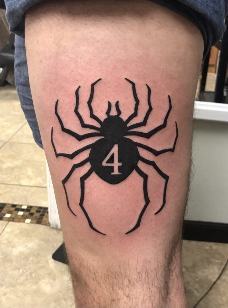 Black spider with number four tattoo
