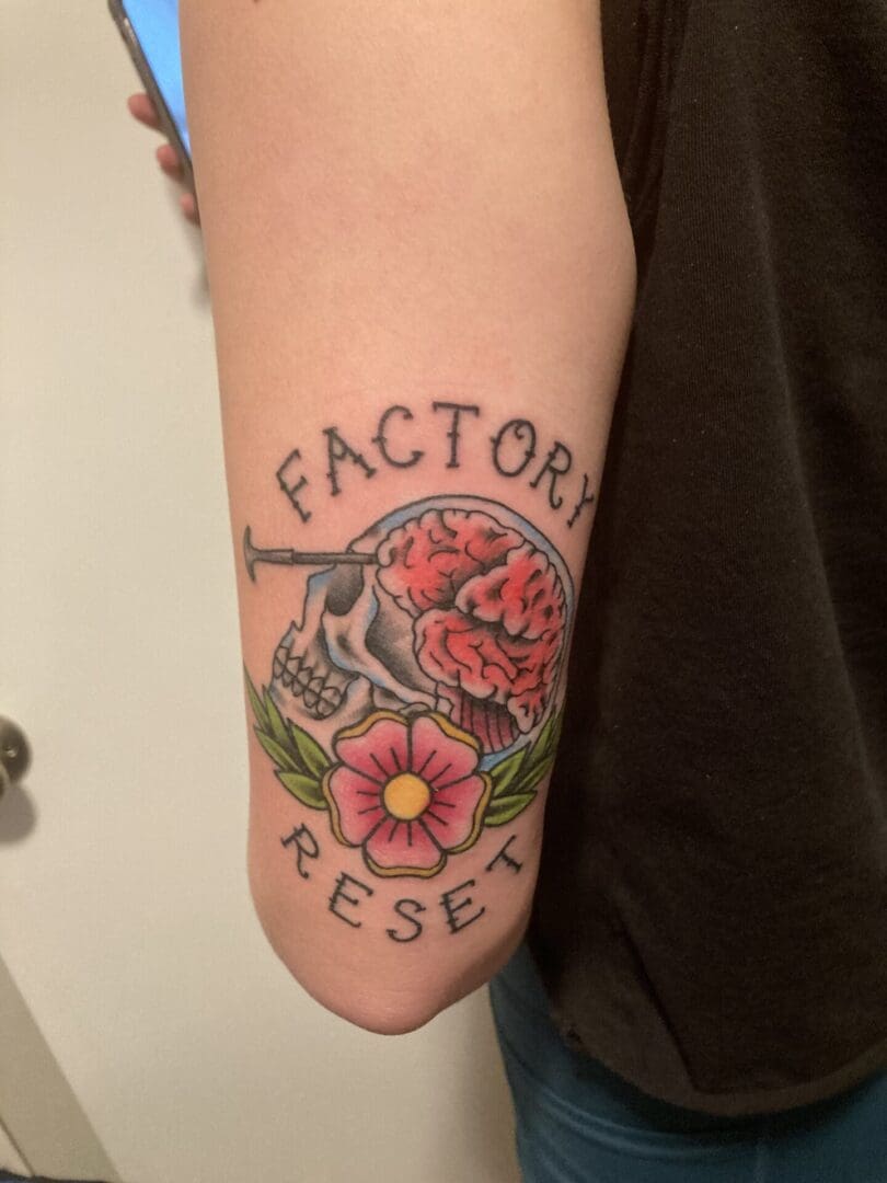 Factory Reset floral tattoo on the backside of the arm