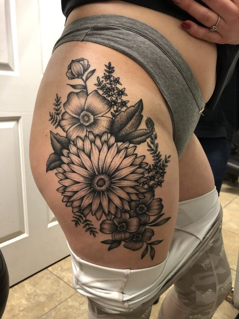 Floral tattoo on the upper leg on a person