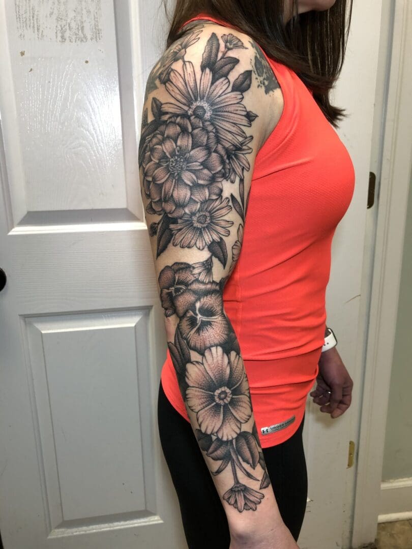 a woman with a flower tattoo on her full arm