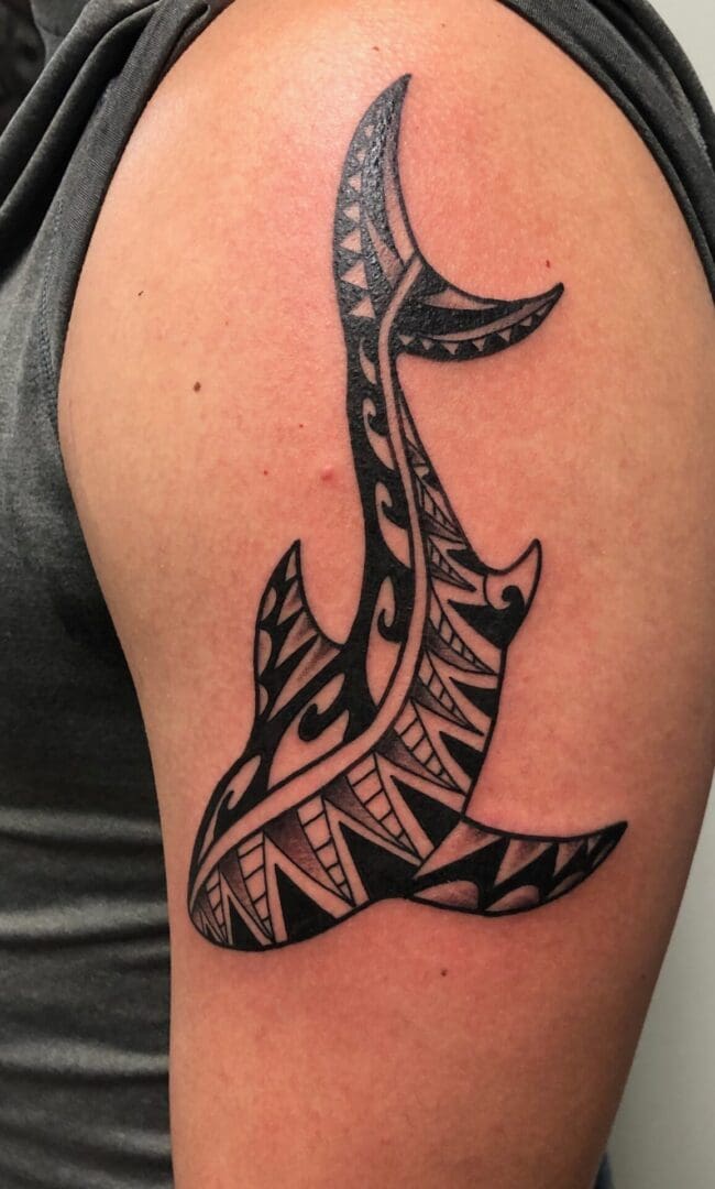 a shark tattoo on the arm of a person