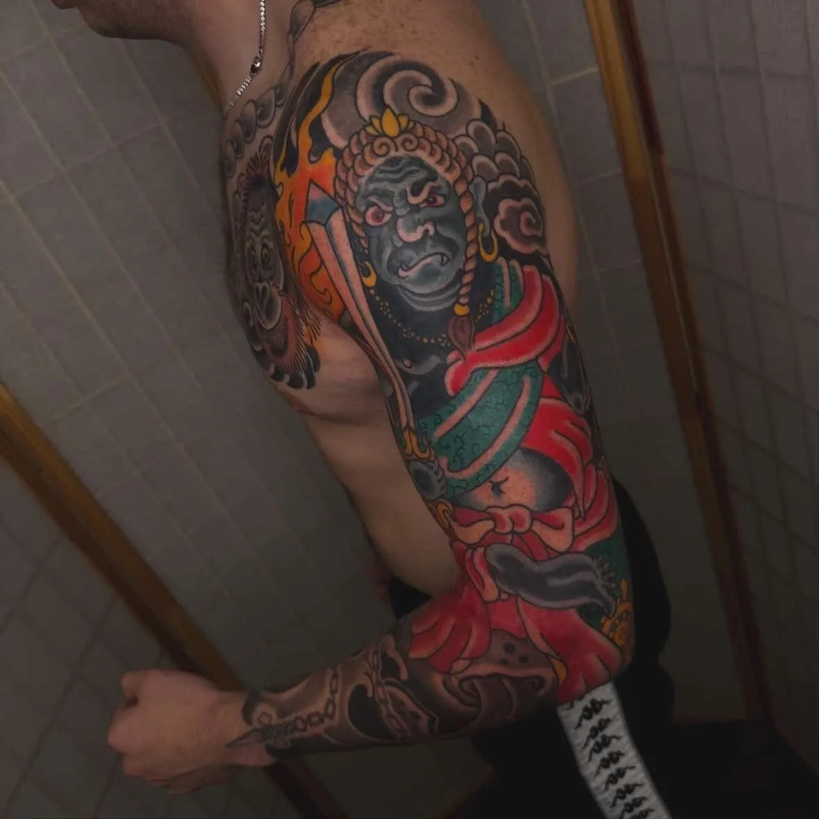 Colorful detailed tattoo on a man's arm.